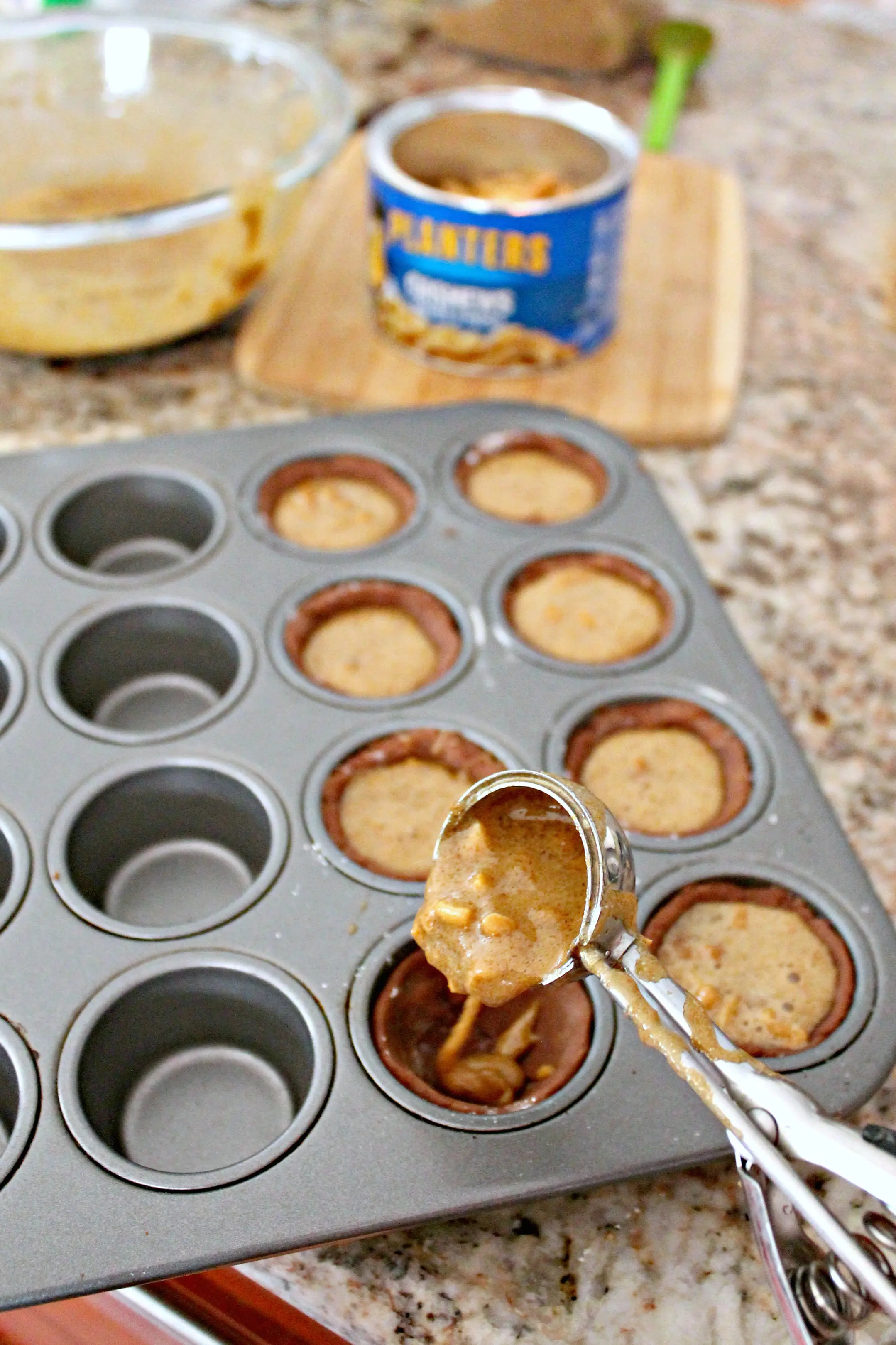 Process shot of scooping filling into Football Pie Cookie Cups