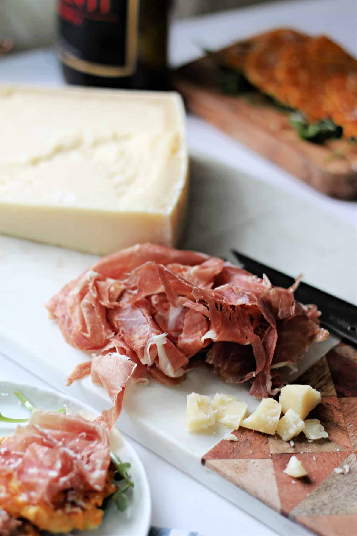 Close up of Prosciutto di San Danielle on a board with cheese.