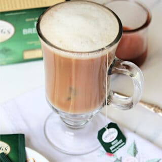 Dublin Fog Tea Latte in a glass mug with tea package in background.