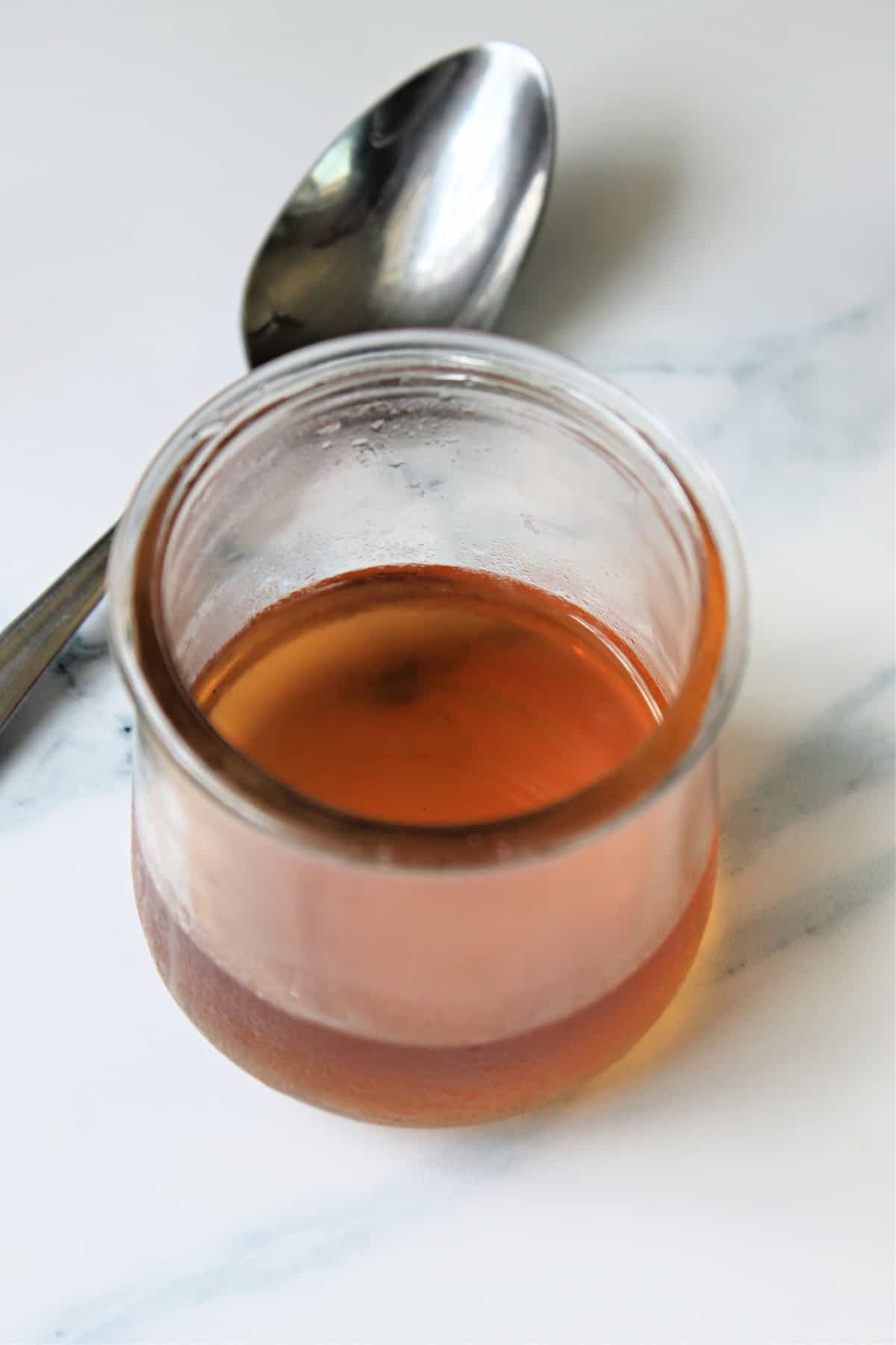 Homemade Vanilla Syrup in a small glass container.