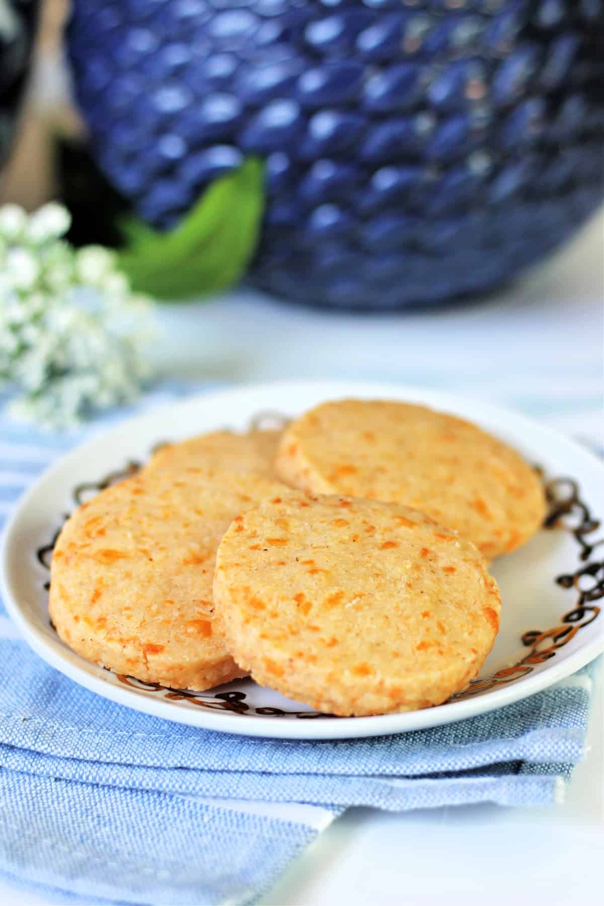 Southern Cheese Straws in coin shape on an appetizer plate.