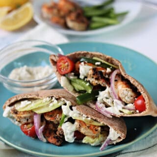 Grilled Greek Shrimp Pita on a teal plate.