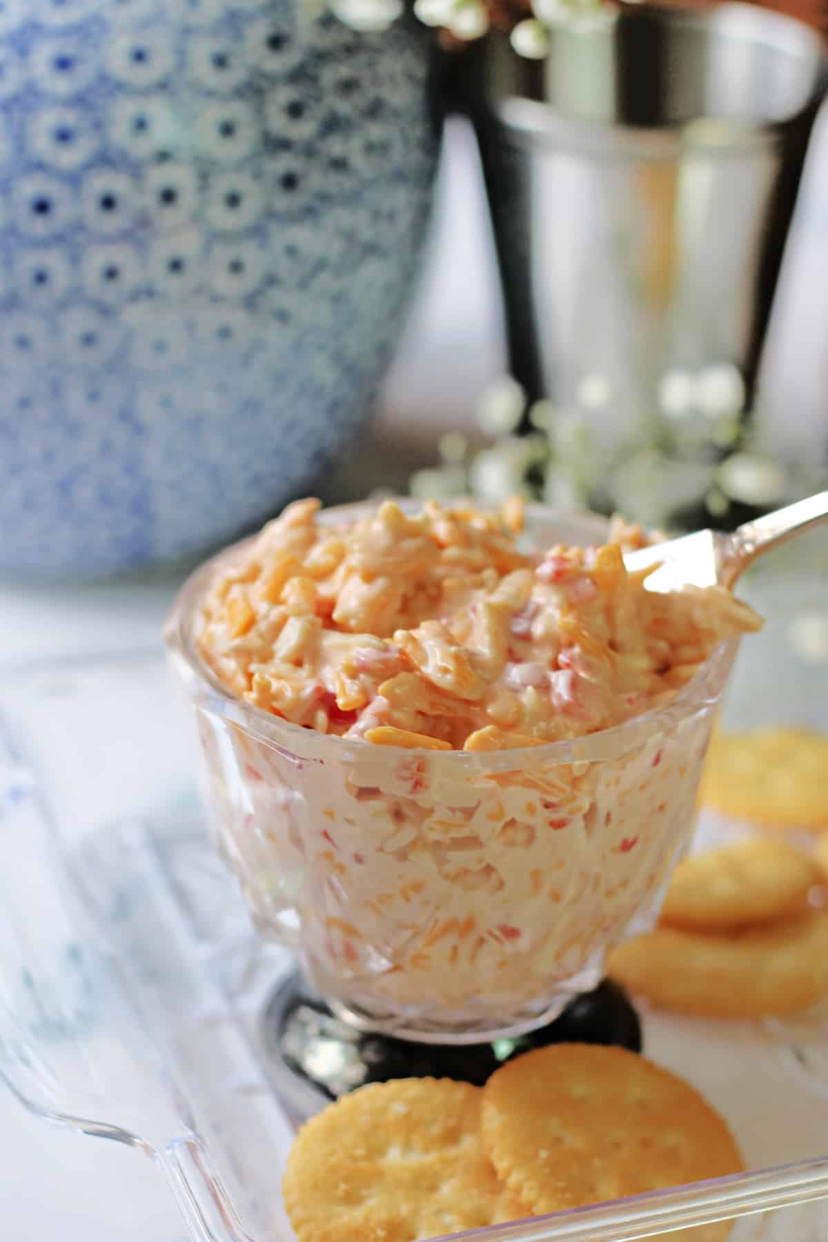 Pimento Cheese in a glass serving dish with crackers.