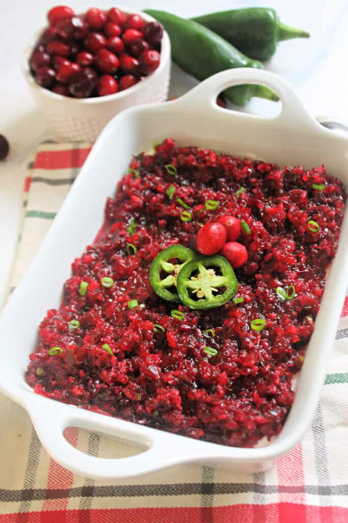 A white serving dish of Cranberry Jalapeno Dip