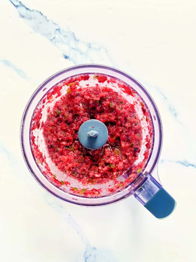 Ingredients for Cranberry Jalapeno Dip processed into a relish in the food processor.