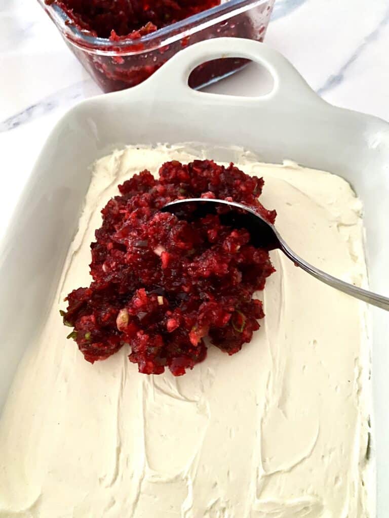 Topping cream cheese mixture for Cranberry Jalapeno Dip with cranberry and jalapeno relish.