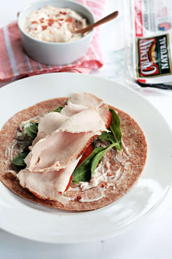 A whole wheat wrap slathered with bacon aioli, topped with lettuce, tomatoes and deli turkey slices.