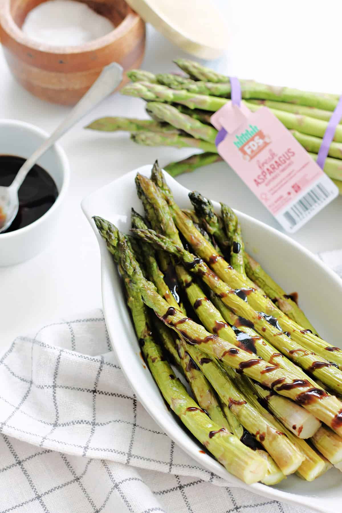 Balsamic Glazed Asparagus in a white serving dish.