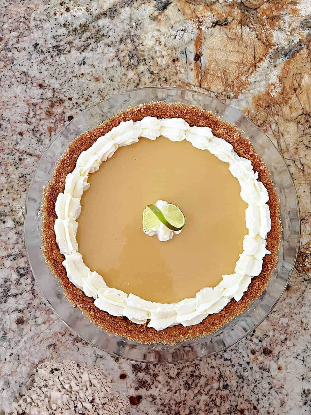 An overhead shot of Key West Key Lime Pie in a glass pie plate.