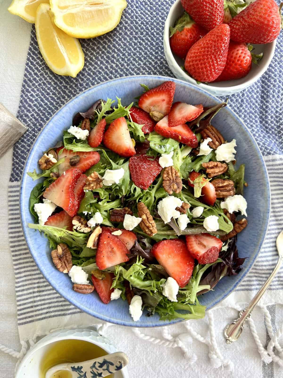 Strawberry Goat Cheese Salad in a blue bowl.