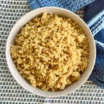 Baked quinoa in a white bowl.