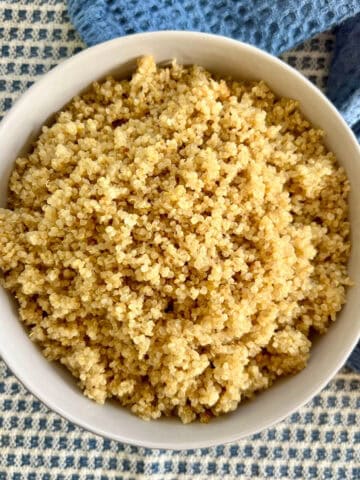 Baked quinoa in a white bowl.