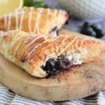 Blueberry Turnovers on a wooden serving platter.