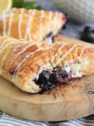 Blueberry Turnovers on a wooden serving platter.