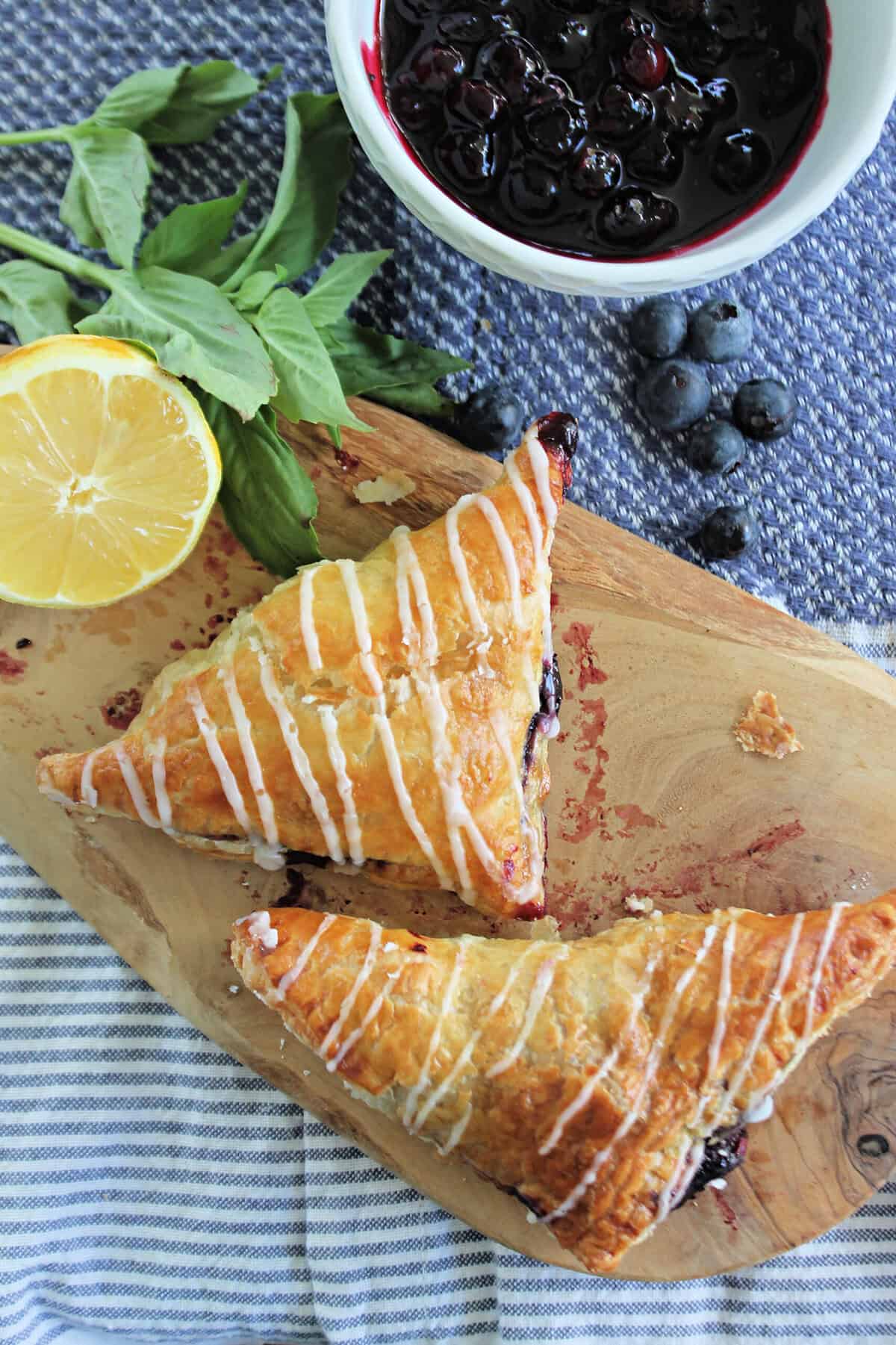 An overhead shot of 2 blueberry puff pastry turnovers.