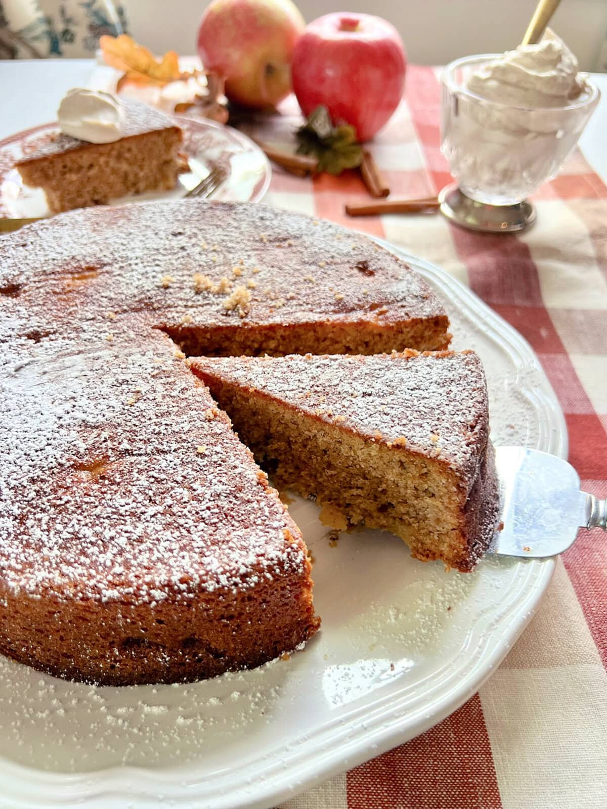 A slice of apple spice cake being cut.