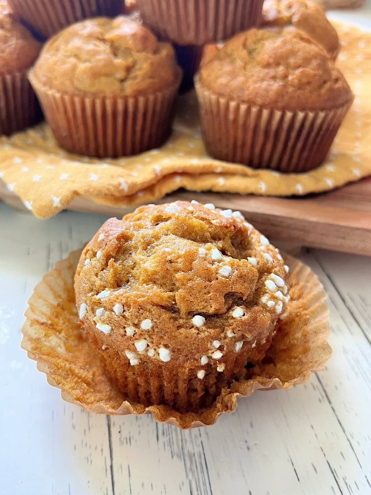 Close up of Pumpkin Banana Bread Muffin with the liner removed to show texture.