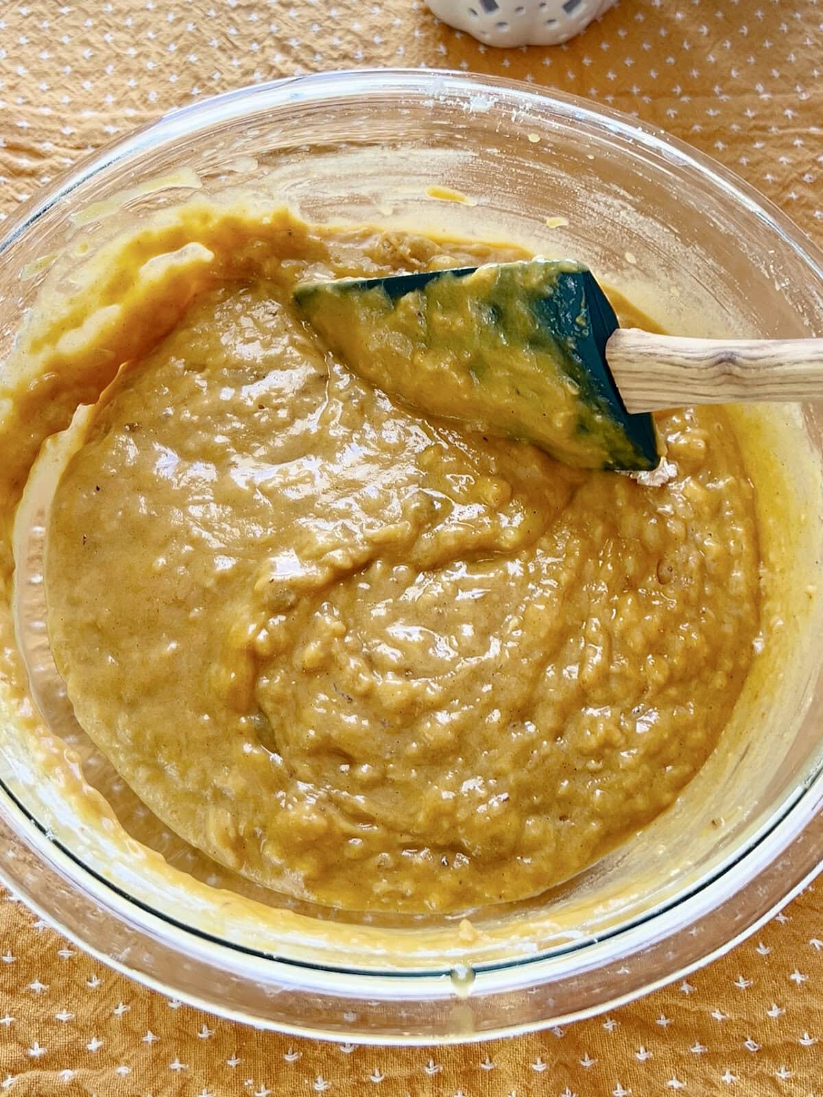 Dry and wet ingredients combined in the batter for Pumpkin Banana Bread Muffins.