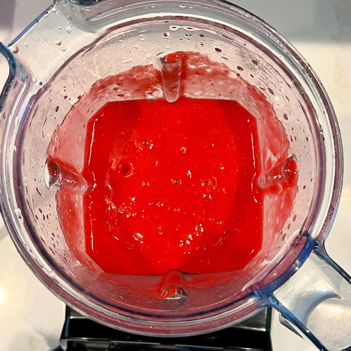 Fresh raspberry mixture for raspberry sorbet in immediately after being blended in the blender.