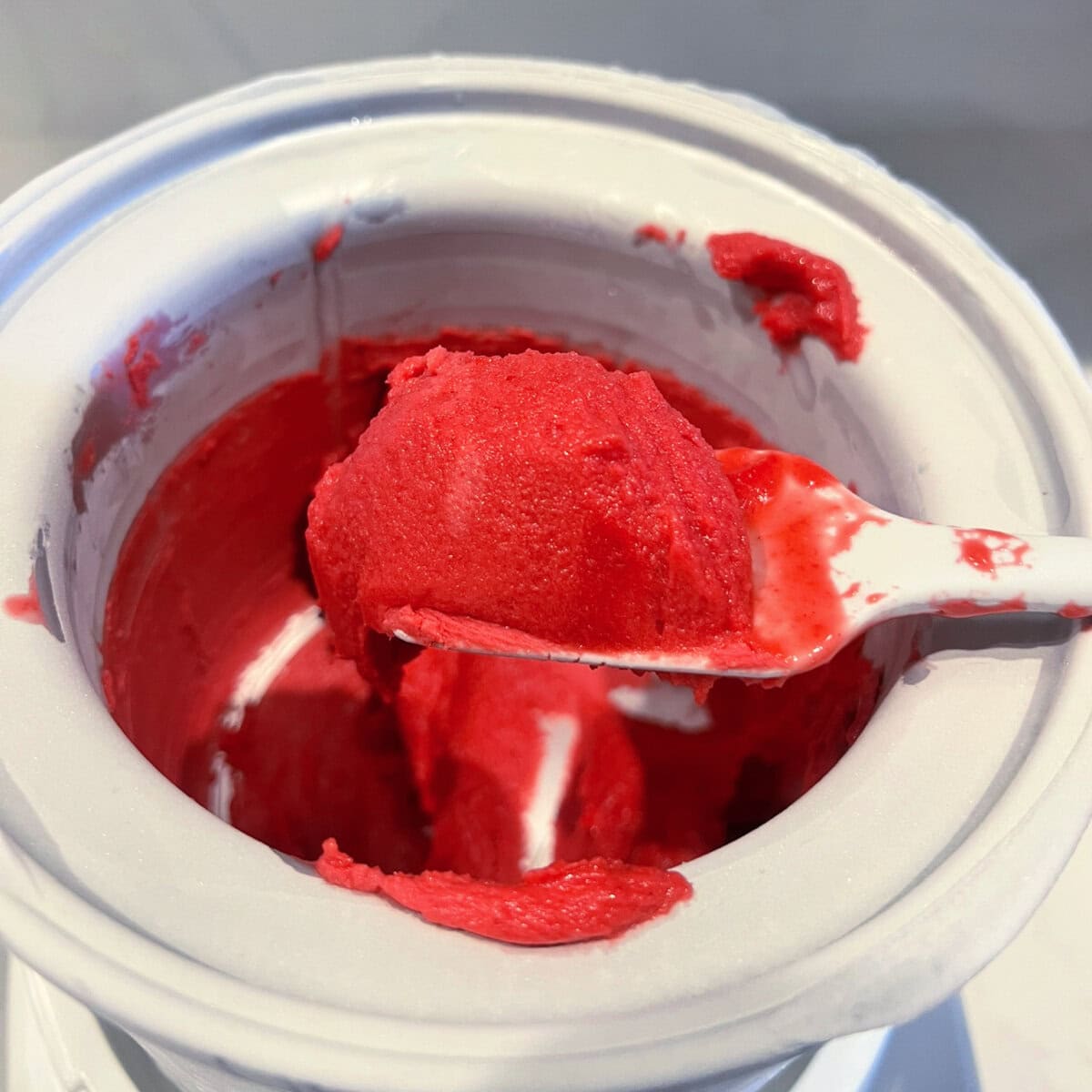 Up close texture of raspberry sorbet immediately after churning in ice cream maker.